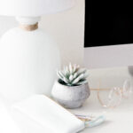 Modern desk setup with lamp, succulent, and accessories