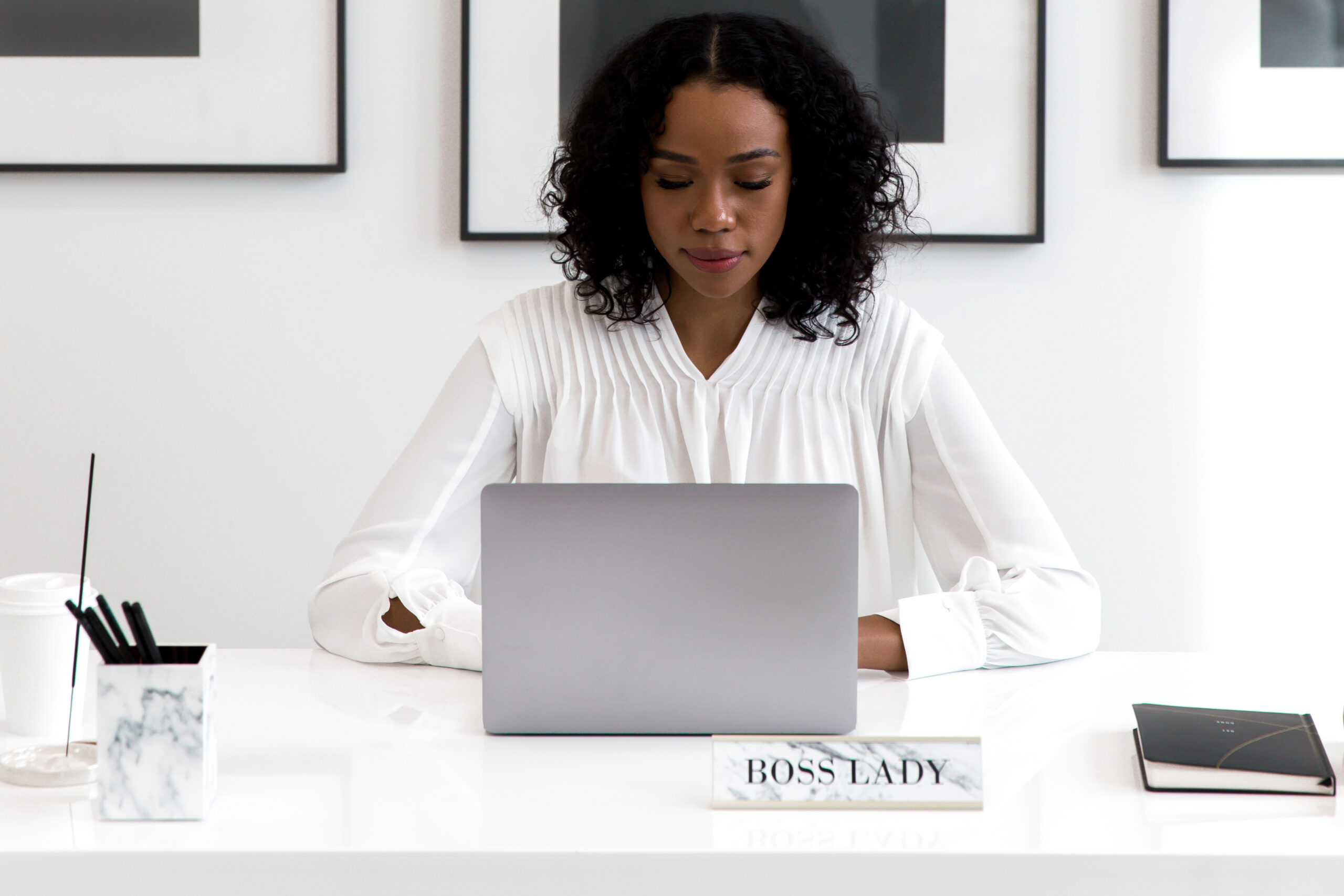Focused woman working on laptop in modern office